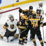 
              Boston Bruins left wing Brad Marchandis congratulated after his goal against Vegas Golden Knights goaltender Logan Thompson during the second period of an NHL hockey game, Monday, Dec. 5, 2022, in Boston. (AP Photo/Charles Krupa)
            