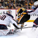 
              Columbus Blue Jackets goaltender Elvis Merzlikins stops a breakaway shot by Pittsburgh Penguins' Teddy Blueger with Tim Berni defending during the second period of an NHL hockey game in Pittsburgh, Tuesday, Dec. 6, 2022. Blueger was awarded a penalty shot on the play, and missed. (AP Photo/Gene J. Puskar)
            
