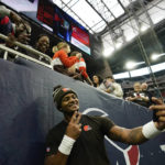 
              Cleveland Browns quarterback Deshaun Watson takes a selfie with fans before of an NFL football game between the Cleveland Browns and Houston Texans in Houston, Sunday, Dec. 4, 2022,. (AP Photo/Eric Christian Smith)
            