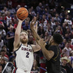 
              Gonzaga forward Drew Timme, left, shoots while defended by Kent State center Cli'Ron Hornbeak during the first half of an NCAA college basketball game, Monday, Dec. 5, 2022, in Spokane, Wash. (AP Photo/Young Kwak)
            