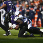 
              Baltimore Ravens quarterback Lamar Jackson (8) is sacked by Denver Broncos linebacker Jonathon Cooper (53), in the first half of an NFL football game, Sunday, Dec. 4, 2022, in Baltimore. (AP Photo/Nick Wass)
            