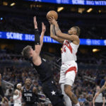 
              Toronto Raptors center Khem Birch (24) goes up to shoot in front of Orlando Magic center Moritz Wagner, center left, as Magic forward Paolo Banchero (5), guard Terrence Ross (31) and guard Cole Anthony (50) watch during the first half of an NBA basketball game, Sunday, Dec. 11, 2022, in Orlando, Fla. (AP Photo/Phelan M. Ebenhack)
            