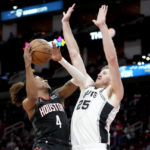 
              Houston Rockets guard Jalen Green (4) shoots as San Antonio Spurs center Jakob Poeltl defends during the second half of an NBA basketball game, Monday, Dec. 19, 2022, in Houston. (AP Photo/Eric Christian Smith)
            