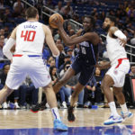
              Orlando Magic center Bol Bol drives to the basket against Los Angeles Clippers center Ivica Zubac (40) and guard Paul George (13) during the first half of an NBA basketball game Wednesday, Dec. 7, 2022, in Orlando, Fla. (AP Photo/Scott Audette)
            
