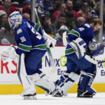
              Vancouver Canucks goalie Spencer Martin (30) leaves the ice and is replaced by goalie Collin Delia (60) after giving up four goals to the Montreal Canadiens during the first period of an NHL hockey game in Vancouver, British Columbia, Monday, Dec. 5, 2022. (Darryl Dyck/The Canadian Press via AP)
            