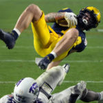 
              Michigan wide receiver Roman Wilson scores a touchdown as *TCU linebacker Jamoi Hodge defends during the second half of the Fiesta Bowl NCAA college football semifinal playoff game, Saturday, Dec. 31, 2022, in Glendale, Ariz. (AP Photo/Rick Scuteri)
            