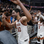 
              Texas forward Brock Cunningham (30) and guard Marcus Carr (5) celebrate with fans after the team's win over Creighton in an NCAA college basketball game in Austin, Texas, Thursday, Dec. 1, 2022. (AP Photo/Eric Gay)
            