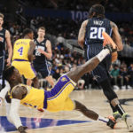 
              Orlando Magic guard Markelle Fultz (20) fouls Los Angeles Lakers guard Dennis Schroder (17) during the first half of an NBA basketball game, Tuesday, Dec. 27, 2022, in Orlando, Fla. (AP Photo/Kevin Kolczynski)
            