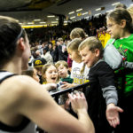 
              Iowa guard Caitlin Clark (22) gives a pair of her shoes to a fan after an NCAA college basketball game against Dartmouth, Wednesday, Dec. 21, 2022, at Carver-Hawkeye Arena in Iowa City, Iowa. Caitlin Clark had 20 points, 10 rebounds and six assists, and reached 2,000 career points as No. 13 Iowa beat Dartmouth 92-54 or its fifth straight victory.(Joseph Cress/Iowa City Press-Citizen via AP)
            