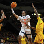 
              Illinois guard Terrence Shannon Jr. (0) goes to the basket for a layup against two Maryland defenders during the first half of an NCAA college basketball game, Friday, Dec. 2, 2022, in College Park, Md. (AP Photo/Terrance Williams)
            