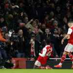 
              Arsenal's Eddie Nketiah, center, celebrates after scoring his side's third goal during the English Premier League soccer match between Arsenal and West Ham United at Emirates stadium in London, Monday, Dec. 26, 2022. (AP Photo/David Cliff)
            