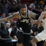 
              Los Angeles Clippers forward Marcus Morris Sr. (8) drives up against Miami Heat guard Dru Smith (9) during the first half of an NBA basketball game, Thursday, Dec. 8, 2022, in Miami. (AP Photo/Wilfredo Lee)
            