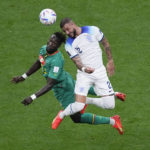 
              Senegal's Moussa Ndiaye, left, and England's Kyle Walker vie for the ball during the World Cup round of 16 soccer match between England and Senegal, at the Al Bayt Stadium in Al Khor, Qatar, Sunday, Dec. 4, 2022. (AP Photo/Darko Bandic)
            