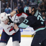 
              Washington Capitals right wing T.J. Oshie (77) and Seattle Kraken center Yanni Gourde fight during the first period of an NHL hockey game Thursday, Dec. 1, 2022, in Seattle. (AP Photo/Jason Redmond)
            