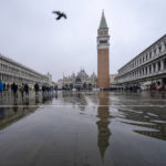 
              St. Mark's Basilica and it's bell tower reflect on the flooded square in Venice, northern Italy, Saturday, Dec. 10, 2022, during a high tide. The tide reached 100 cm above the sea level flooding the lower areas of the city. (AP Photo/Domenico Stinellis)
            