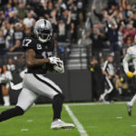 
              Las Vegas Raiders wide receiver Davante Adams (17) carries on a touchdown reception during the second half of an NFL football game against the Los Angeles Chargers, Sunday, Dec. 4, 2022, in Las Vegas. (AP Photo/David Becker)
            