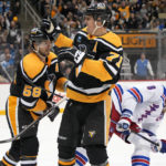 
              Pittsburgh Penguins' Evgeni Malkin (71) celebrates his goal against the New York Rangers with Kris Letang (58) during the second period of an NHL hockey game in Pittsburgh, Tuesday, Dec. 20, 2022. (AP Photo/Gene J. Puskar)
            