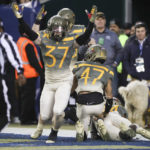 
              Army players celebrate after Army defensive back Noah Short (47) blocked a punt return by Navy punter Riley Riethman (90) for a touchdown in the second quarter of an NCAA college football game in Philadelphia, Saturday, Dec. 10, 2022. (Heather Khalifa/The Philadelphia Inquirer via AP)
            
