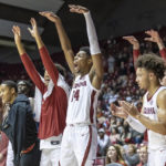 
              Alabama forward Brandon Miller (24) and other Alabama teammates cheer for the reserves in the final minutes during the second half of an NCAA college basketball game against Jackson State, Tuesday, Dec. 20, 2022, in Tuscaloosa, Ala. (AP Photo/Vasha Hunt)
            