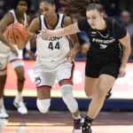 
              Connecticut's Aubrey Griffin (44) is fouled by Providence's Meghan Huerter (3) while stealing the ball in the first half of an NCAA college basketball game, Friday, Dec. 2, 2022, in Storrs, Conn. (AP Photo/Jessica Hill)
            