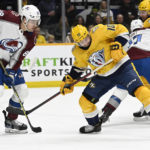 
              Nashville Predators center Colton Sissons (10) reaches for the puck with his skate as he tries to get control as Colorado Avalanche defenseman Andreas Englund (88) defends during the second period of an NHL hockey game Friday, Dec. 23, 2022, in Nashville, Tenn. (AP Photo/Mark Zaleski)
            