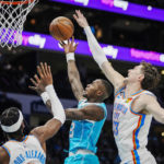 
              Charlotte Hornets guard Terry Rozier, second from right, drives to the basket between Oklahoma City Thunder center Mike Muscala, right, and guard Shai Gilgeous-Alexander, second from left, during the first half of an NBA basketball game Thursday, Dec. 29, 2022, in Charlotte, N.C. (AP Photo/Rusty Jones)
            
