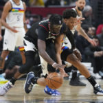 
              Los Angeles Clippers guard Reggie Jackson, left, and Minnesota Timberwolves guard Wendell Moore Jr. reach for a loose ball during the first half of an NBA basketball game in Los Angeles, Wednesday, Dec. 14, 2022. (AP Photo/Ashley Landis)
            