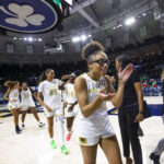 
              Notre Dame's Olivia Miles celebrates as she walks off the court after an NCAA college basketball game against Connecticut on Sunday, Dec. 4, 2022, in South Bend, Ind. (AP Photo/Michael Caterina)
            