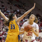 
              Indiana forward Alyssa Geary (32) shoots while being defended by Morehead State center Isabel Gonzalez (33) during the second half of an NCAA college basketball game, Sunday, Dec. 18, 2022, in Bloomington, Ind. (AP Photo/Doug McSchooler)
            