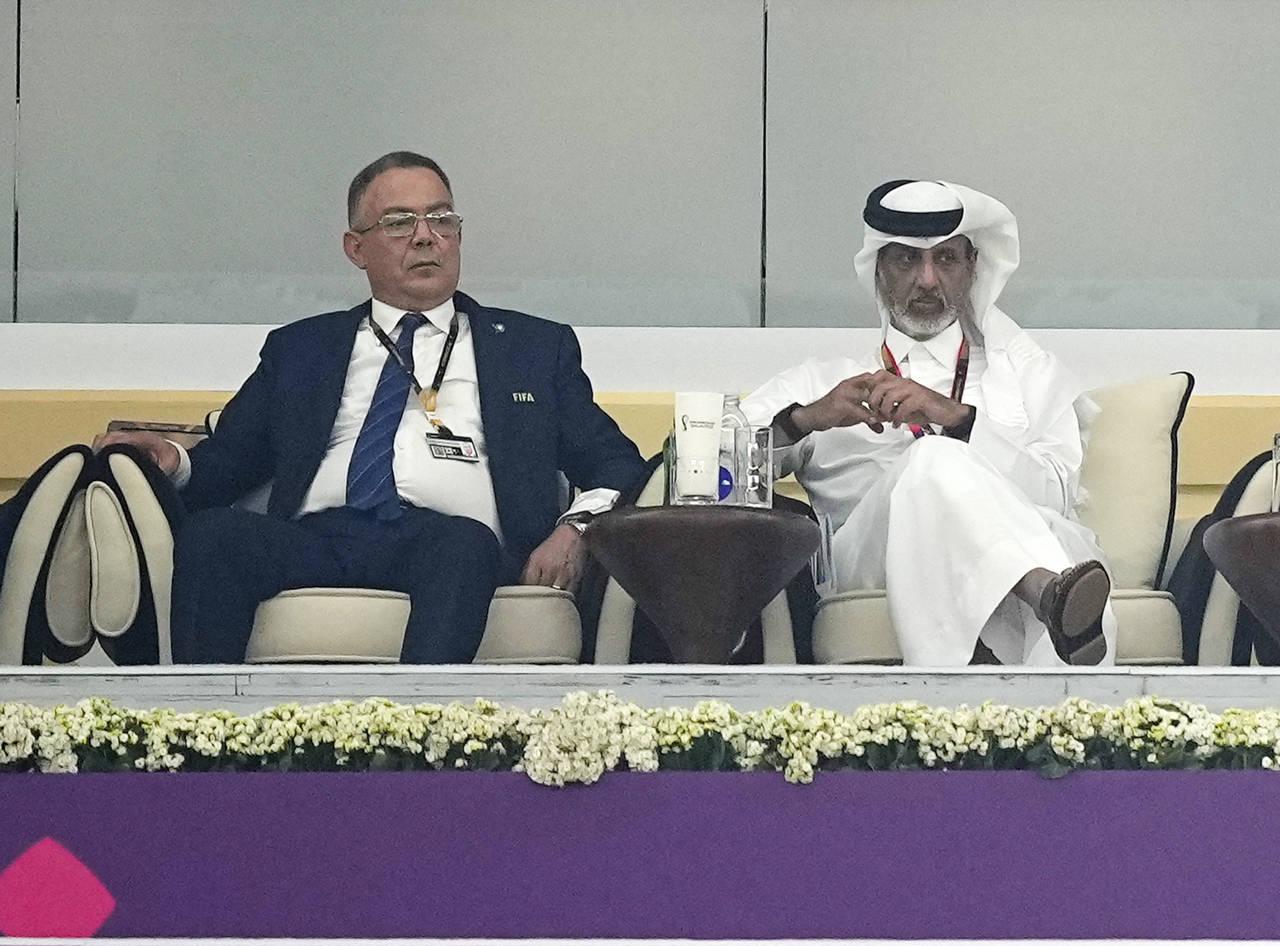 Moroccan FA President Fouzi Lekjaa, left, sits in the tribune for the World Cup semifinal soccer ma...