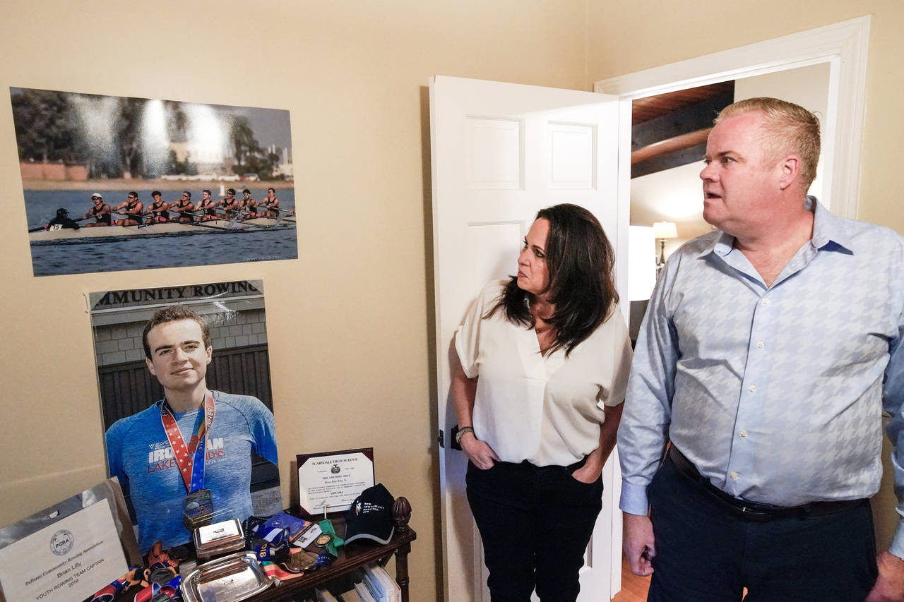 Brenda and Brian Lilly look at photos of their son Brian Lilly Jr. in their Easton, Conn. home, Thu...