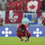 
              Canada forward Alphonso Davies (19) reacts after a loss to Morocco in a group F World Cup soccer match at the Al Thumama Stadium in Doha, Qatar on Thursday, Dec. 1, 2022. (Nathan Denette/The Canadian Press via AP)
            
