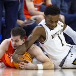 
              Notre Dame's JJ Starling (1) and Syracuse's Joseph Girard III, left, fight for a loose ball during the first half of an NCAA college basketball game on Saturday, Dec. 3, 2022 in South Bend, Ind. (AP Photo/Michael Caterina)
            