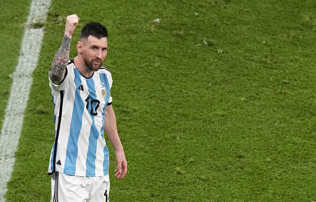 Argentina's Lionel Messi celebrates at the end of the World Cup semifinal soccer match between Arge...
