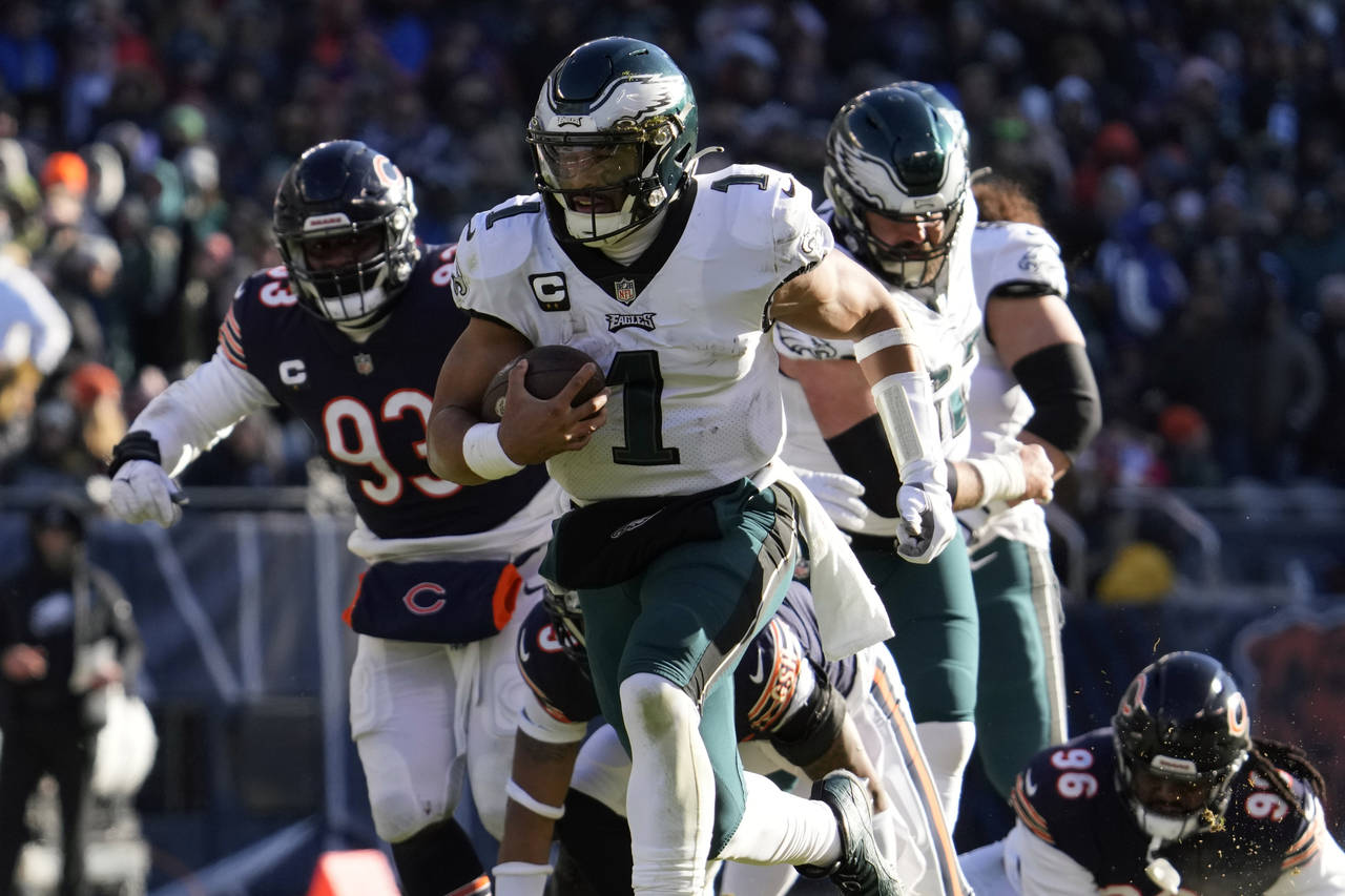 Philadelphia Eagles' Jalen Hurts runs for a touchdown during the first half of an NFL football game...