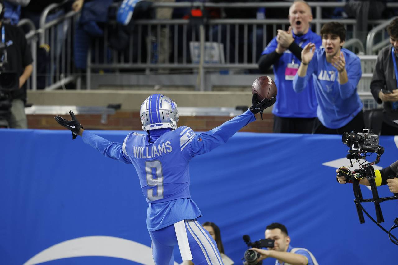 Detroit Lions' Jameson Williams reacts after catching a touchdown pass during the first half of an ...