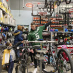 
              New York Jets quarterback Mike White helps a student from Brooklyn Community Services' Jets Academy shop for a bicycle at Dick's Sporting Goods in East Hanover, N.J., on Tuesday, Dec. 13, 2022. The Jets hosted a holiday shopping spree for 25 students from Brooklyn Community Services' Jets Academy. (AP Photo/Dennis Waszak Jr.)
            