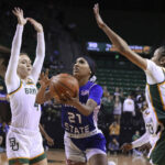 
              Tennessee State guard Zyion Shannon (21) shoots between Baylor guards Jana Van Gytenbeek (4) and Darianna Littlepage-Buggs (5) in the first half of an NCAA college basketball game, Thursday, Dec. 15, 2022, in Waco, Texas. (Rod Aydelotte/Waco Tribune-Herald, via AP)
            