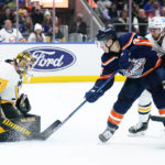 
              Pittsburgh Penguins goaltender Tristan Jarry (35) stops a shot on goal by New York Islanders' Jean-Gabriel Pageau during the second period of an NHL hockey game, Tuesday, Dec. 27, 2022, in Elmont, N.Y. (AP Photo/Frank Franklin II)
            