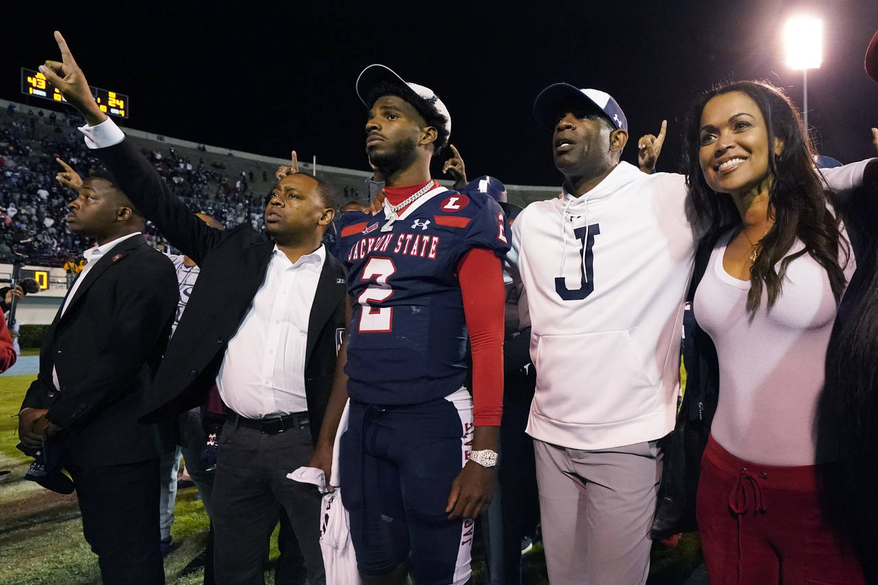 Jackson State coach Deion Sanders, second from right, and his son and quarterback Shedeur Sanders (...
