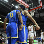 
              UCLA guard Jaylen Clark (0) is greeted by UCLA guard Jaime Jaquez Jr. after being fouled by Maryland guard Jahmir Young during the first half of an NCAA college basketball game, Wednesday, Dec. 14, 2022, in College Park, Md. (AP Photo/Terrance Williams)
            