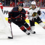 
              Carolina Hurricanes' Brady Skjei (76) passes the puck away from Chicago Blackhawks' Max Domi (13) during the first period of an NHL hockey game in Raleigh, N.C., Tuesday, Dec. 27, 2022. (AP Photo/Karl B DeBlaker)
            