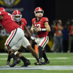 
              Georgia quarterback Stetson Bennett (13) looks for an open receiver in the first half of the Southeastern Conference Championship football game against the LSU Saturday, Dec. 3, 2022 in Atlanta. (AP Photo/John Bazemore)
            