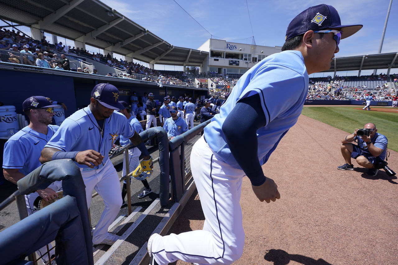 FILE - Tampa Bay Rays first baseman Ji-Man Choi, front right, is followed onto the field by shortst...