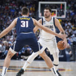
              Dallas Mavericks guard Luka Doncic, back, is defended by Denver Nuggets forward Vlatko Cancar during the first half of an NBA basketball game Tuesday, Dec. 6, 2022, in Denver. (AP Photo/David Zalubowski)
            