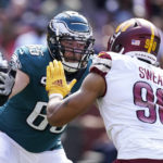 
              FILE - Philadelphia Eagles offensive tackle Lane Johnson (65) works against Washington Commanders defensive end Montez Sweat (90) during the first half of an NFL football game Sept. 24, 2022, in Landover, Md. Eagles quarterback Jalen Hurts is among the top candidates for AP NFL MVP mainly due to a dominant line that protects him and paves the way for one of the league’s best rushing attacks. The Eagles are 11-1 for the fourth time in franchise history thanks to a dynamic offense and stingy defense. (AP Photo/Alex Brandon, File)
            