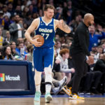 
              Dallas Mavericks guard Luka Doncic smiles after a foul is called on him in the second half of an NBA basketball game against the Los Angeles Lakers in Dallas, Sunday, Dec. 25, 2022. (AP Photo/Emil T. Lippe)
            