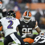 
              Cleveland Browns defensive end Myles Garrett (95) moves to tackle Baltimore Ravens quarterback Tyler Huntley during the second half of an NFL football game, Saturday, Dec. 17, 2022, in Cleveland. (AP Photo/Ron Schwane)
            