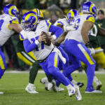 
              Los angles Rams quarterback Baker Mayfield (17) rolls out to pass against the Green Bay Packers in the first half of an NFL football game in Green Bay, Wis. Monday, Dec. 19, 2022. (AP Photo/Mike Roemer)
            