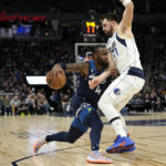 
              Minnesota Timberwolves guard Jaylen Nowell (4) works towards the basket while defended by Dallas Mavericks guard Luka Doncic (77) during the first half of an NBA basketball game, Wednesday, Dec. 21, 2022, in Minneapolis. (AP Photo/Abbie Parr)
            
